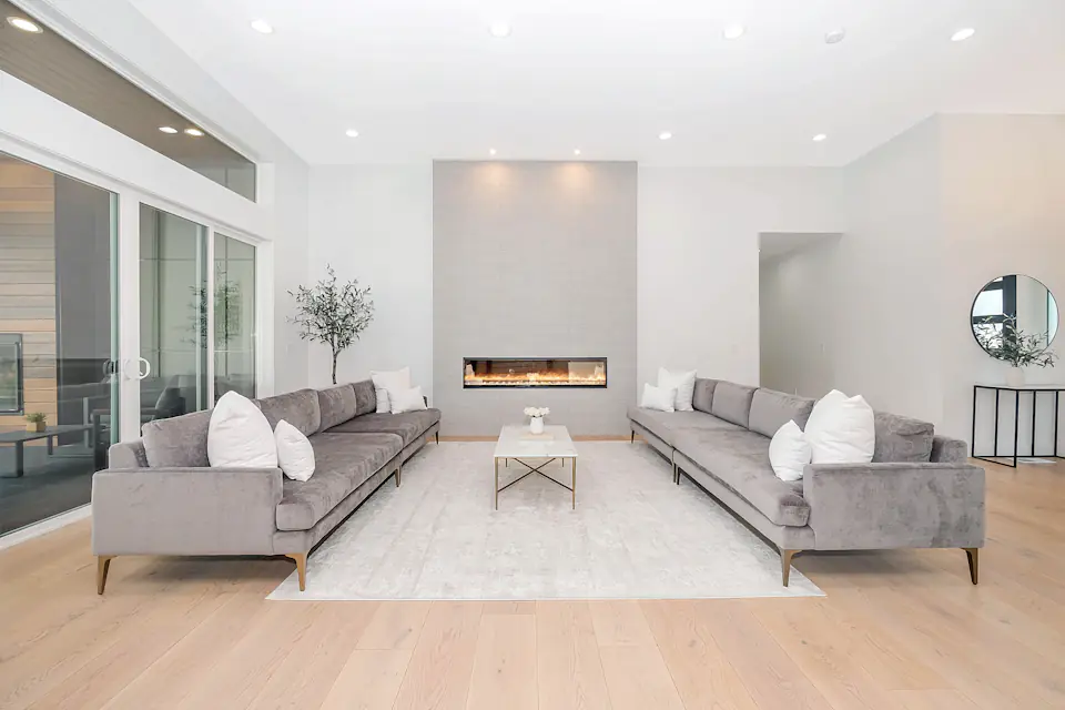 Sofas placed after a furniture removal Two grey velvet sofas facing each other in a bright modern living room