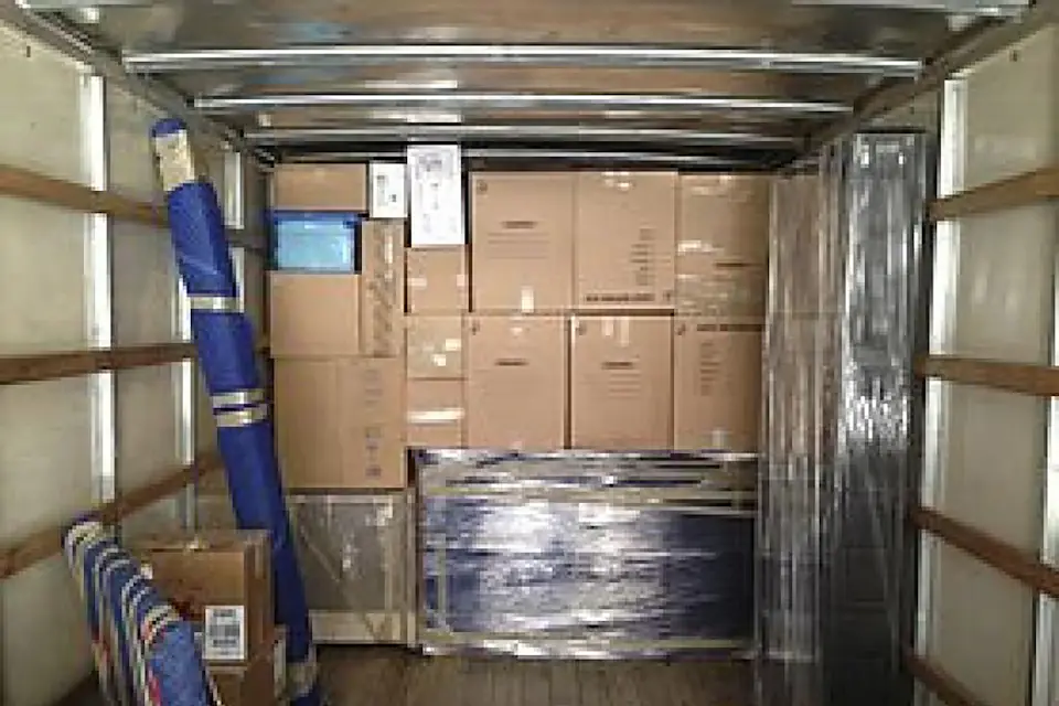 Wrapped load for a long distance removal from Newcastle Inside a removal truck with boxes and furniture wrapped in plastic film