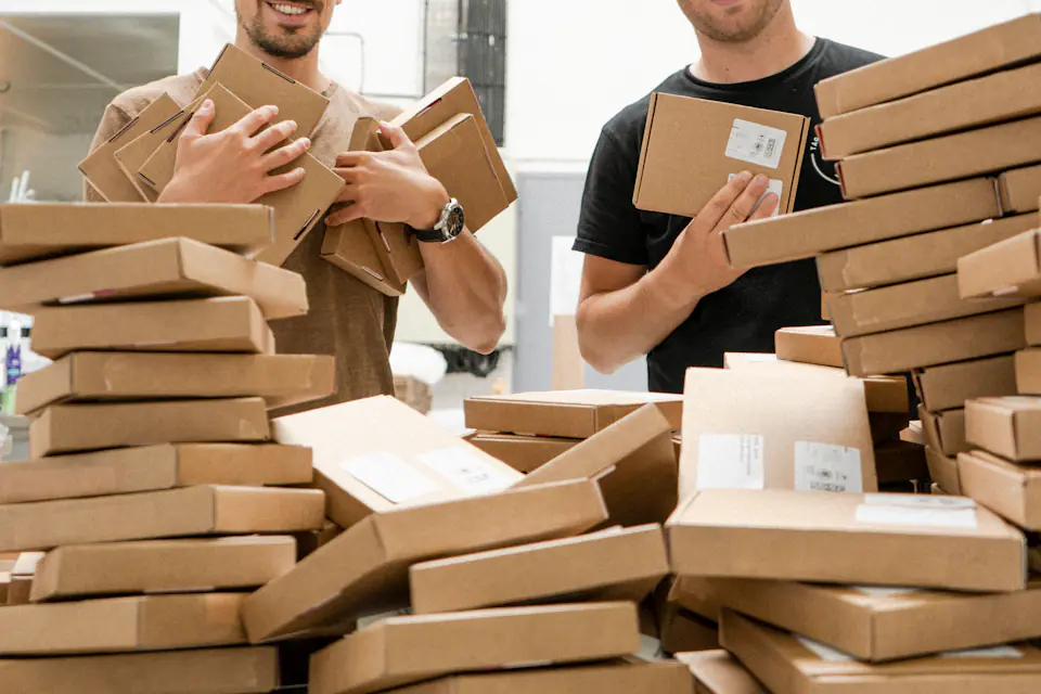 Packing service in Newcastle Two men surrounded by flat-packed and assembled cardboard boxes